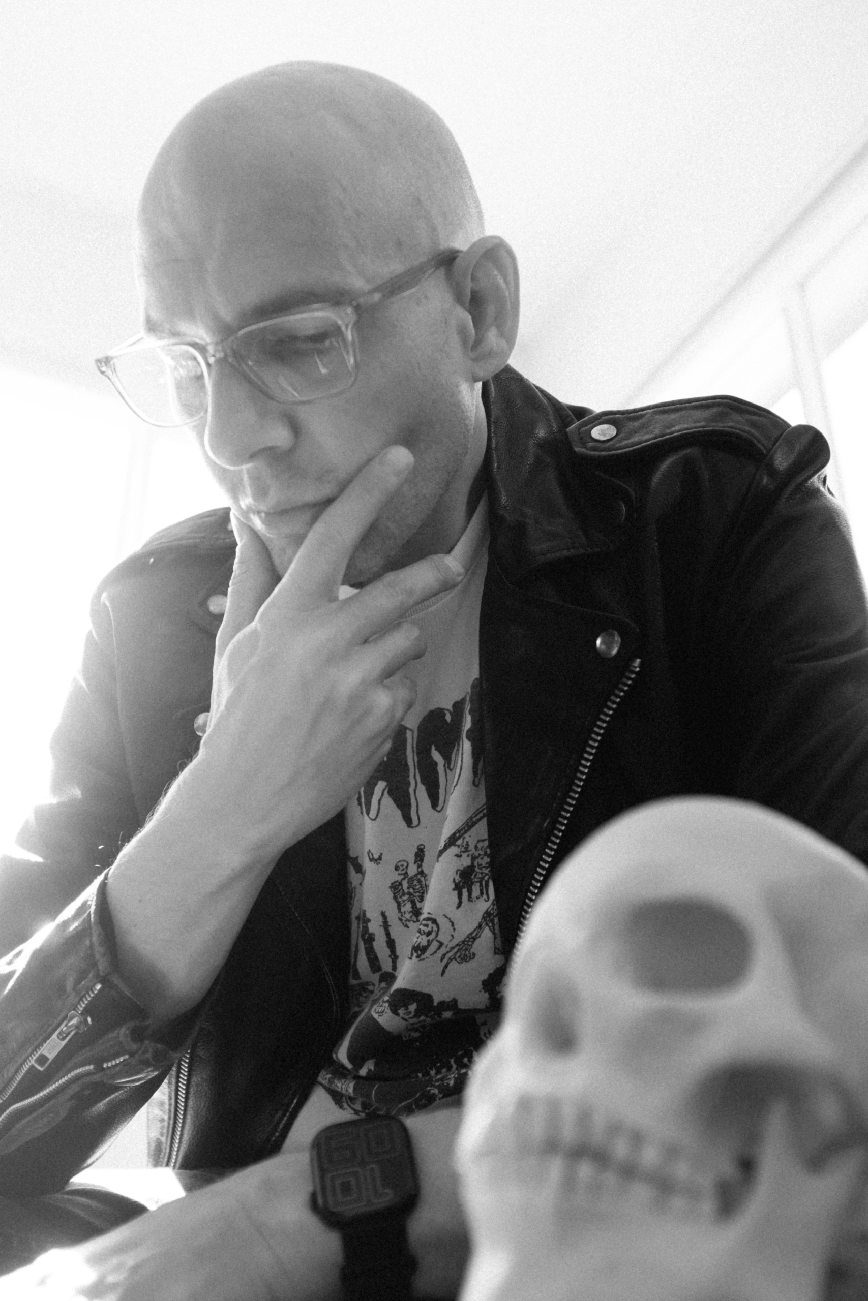 Portrait of Artist Dan Almasy with abstract red backdrop and white hand drawn rings imitating a halo